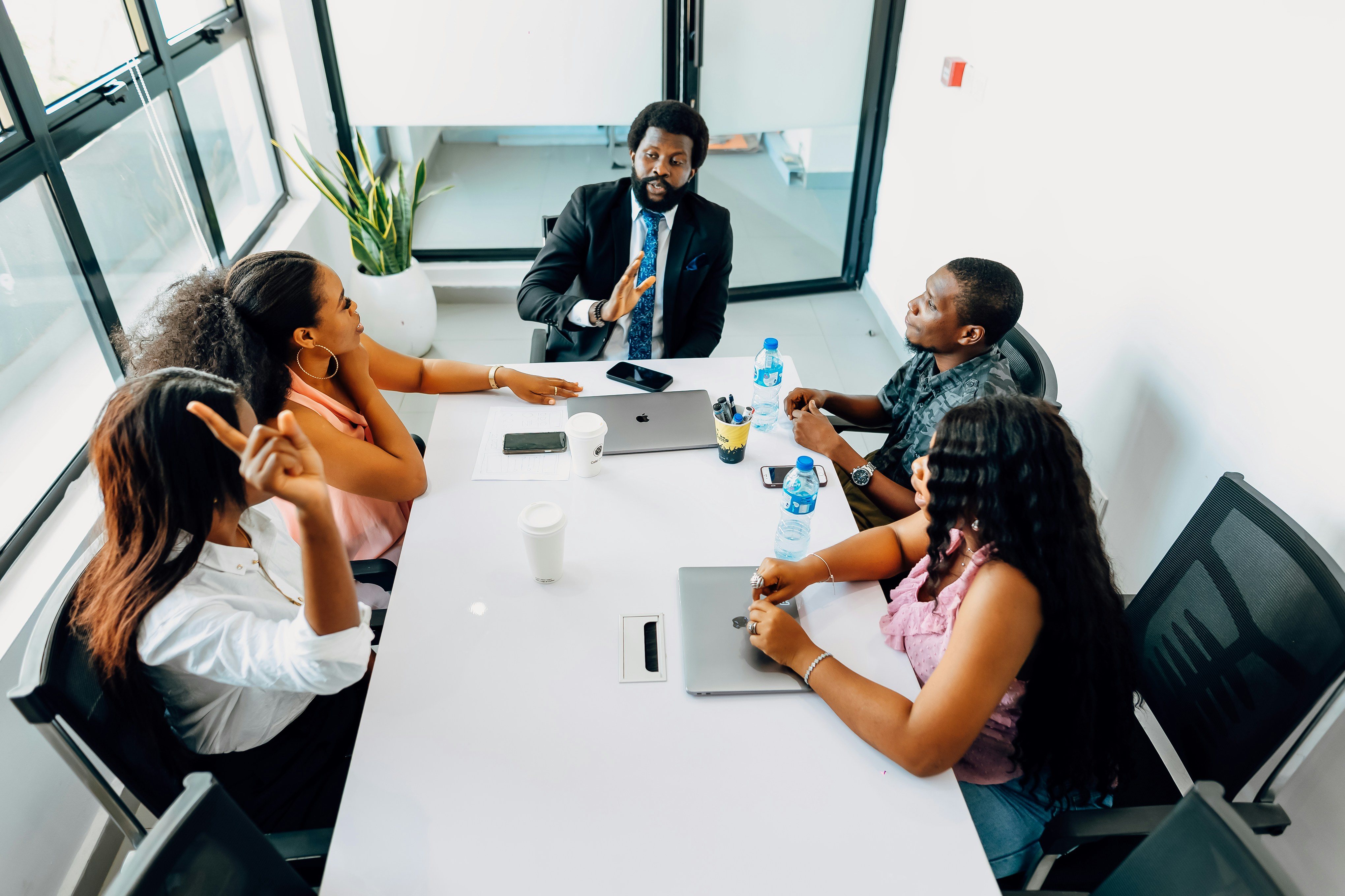 Professional Black business team in strategic meeting around conference table
